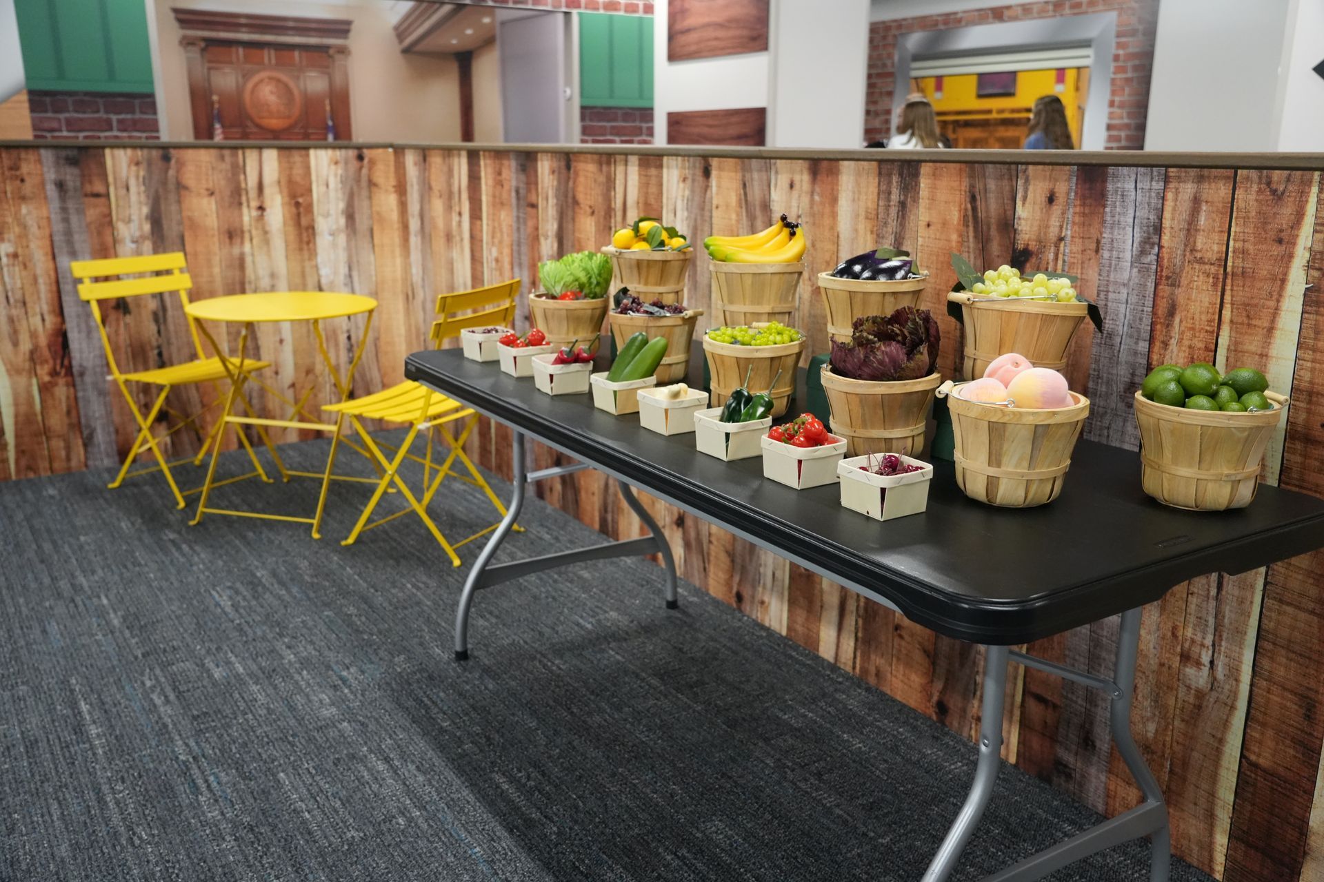 A table with baskets of fruit and vegetables on it