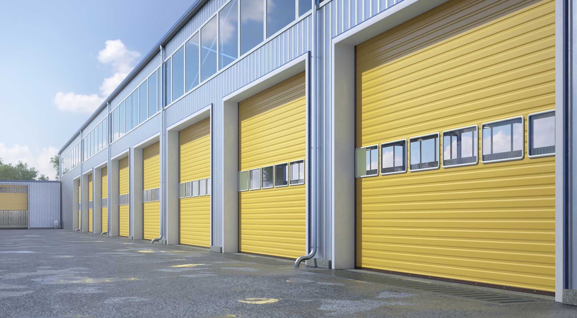 A row of yellow garage doors on the side of a building.