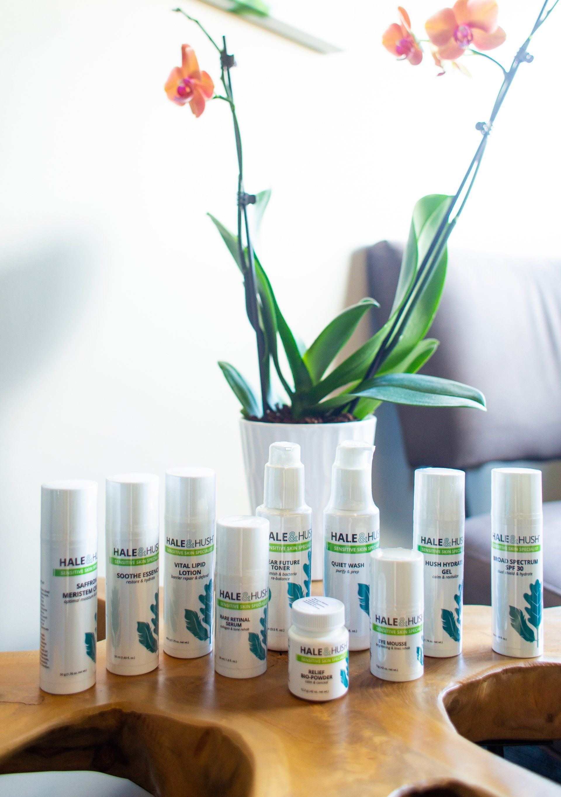 A bunch of bottles are sitting on a wooden table