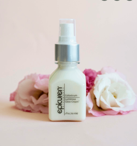 A bottle of epikuren lotion is next to some pink flowers