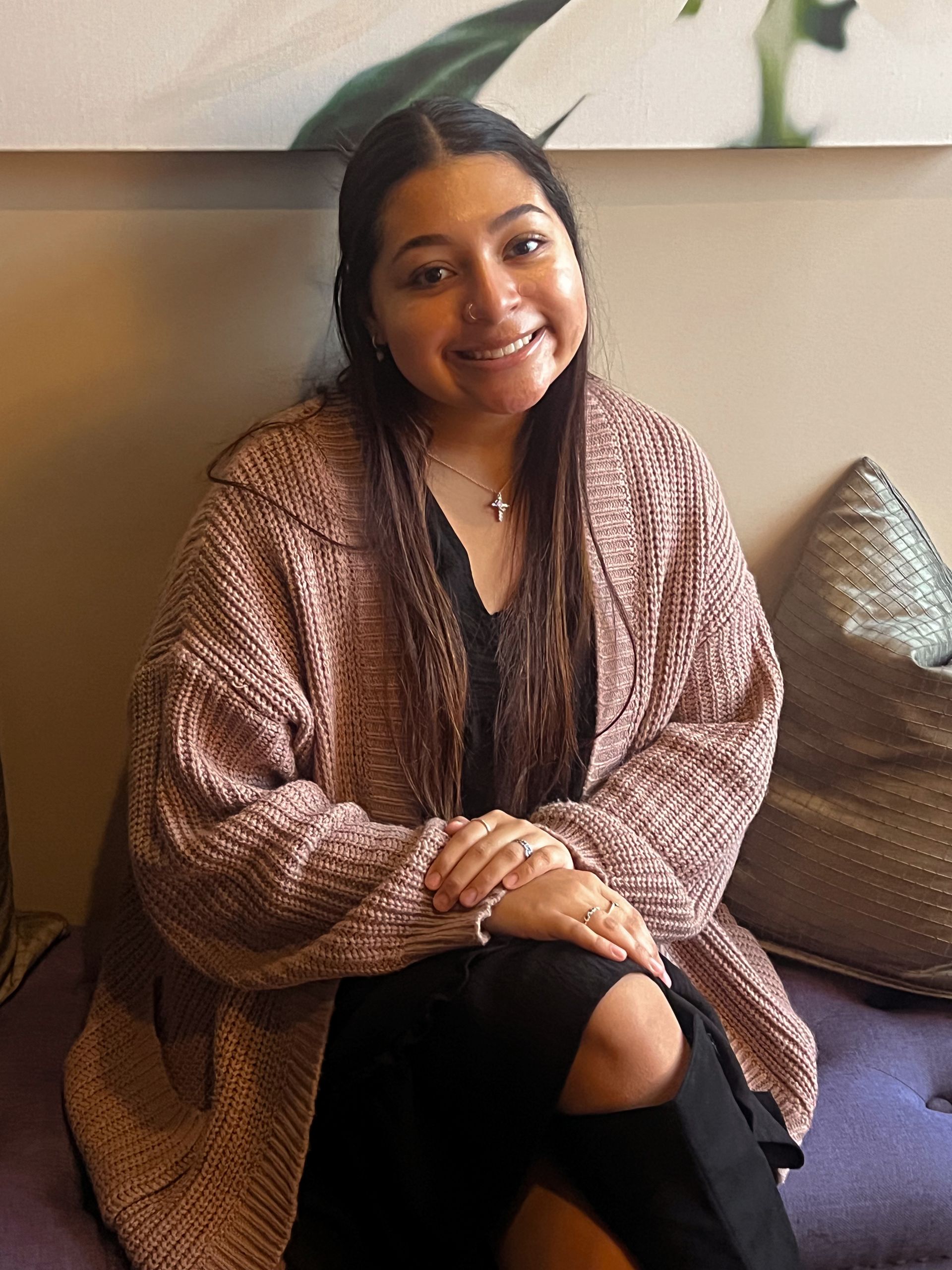 A woman standing in front of a metal tree