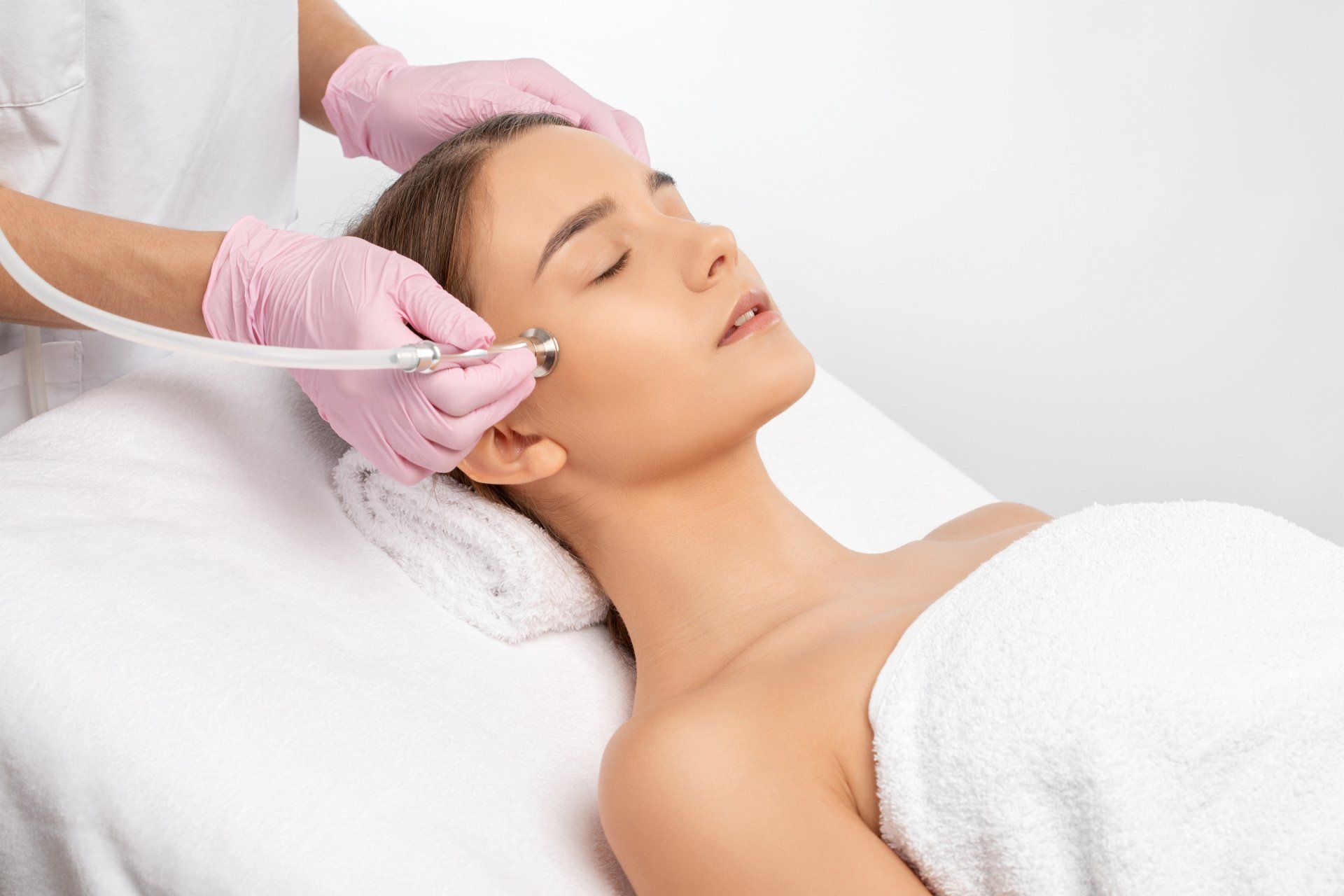 A woman is getting a facial treatment at a spa.