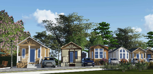 Row of small houses with cars parked in front, trees and blue sky background.