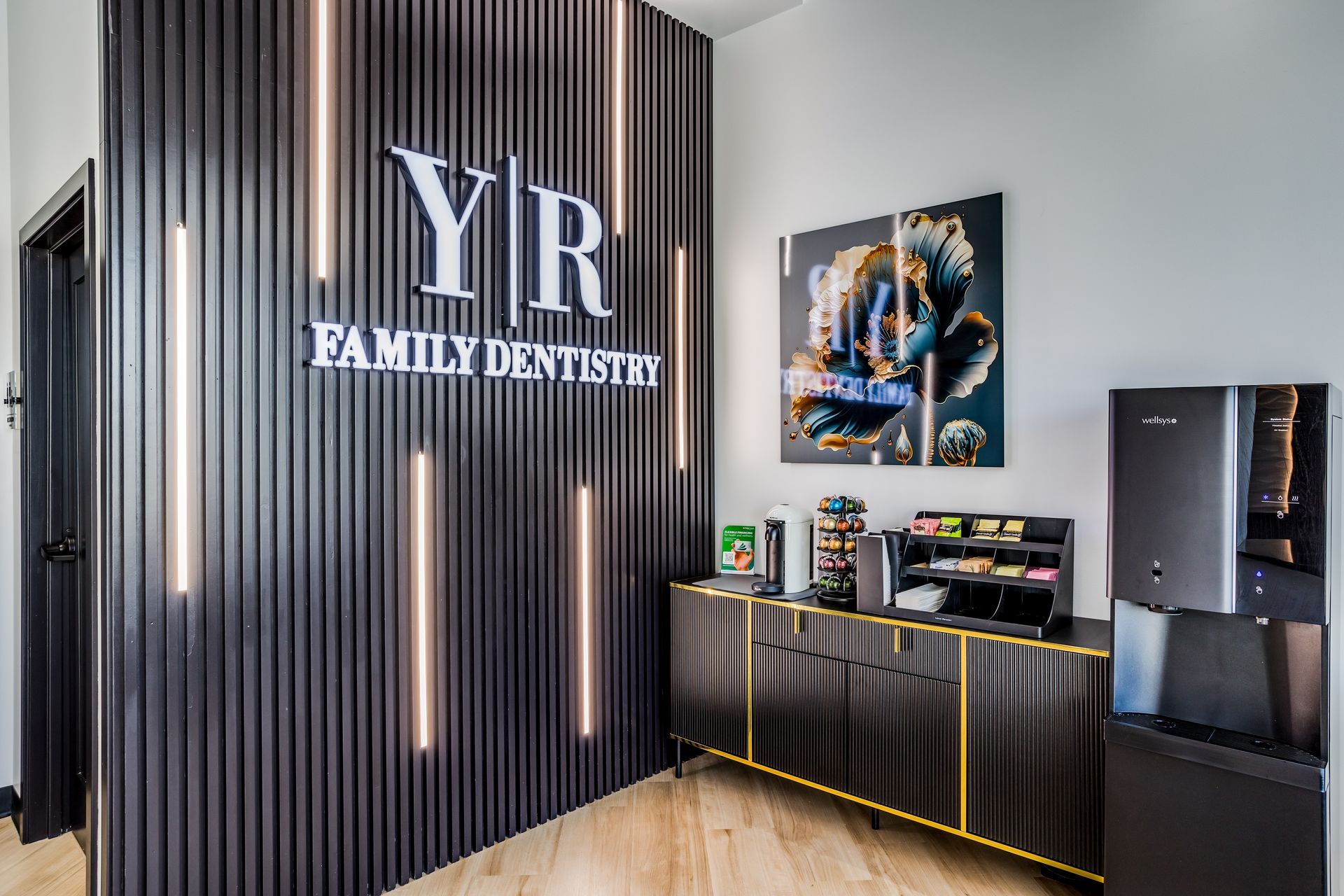 A room with a sign on the wall that says `` yr family dentists ''.