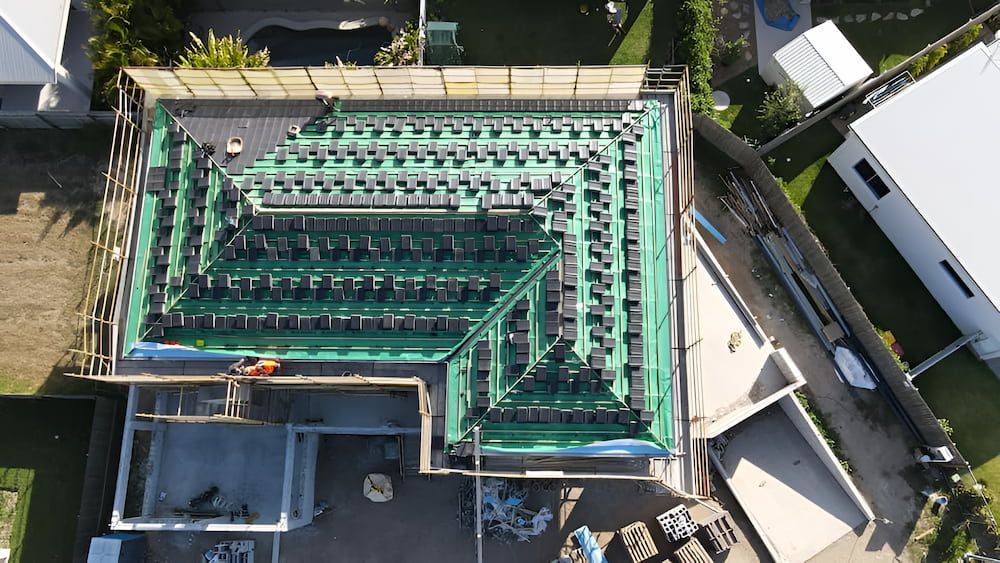 An Aerial View of a House Under Construction With a Green Roof — High Performance Roof Tiling P/L in Tully, QLD