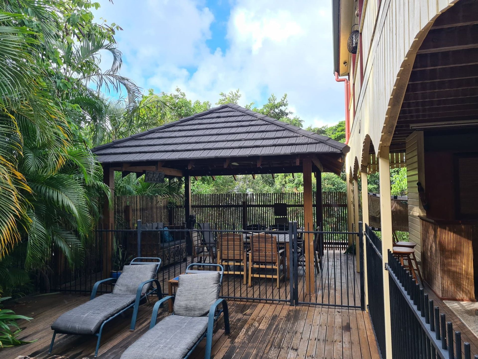 Lounge Chairs on A Deck Overlooking a Gazebo with A Dining Table — High Performance Roof Tiling P/L in Kewarra Beach, QLD