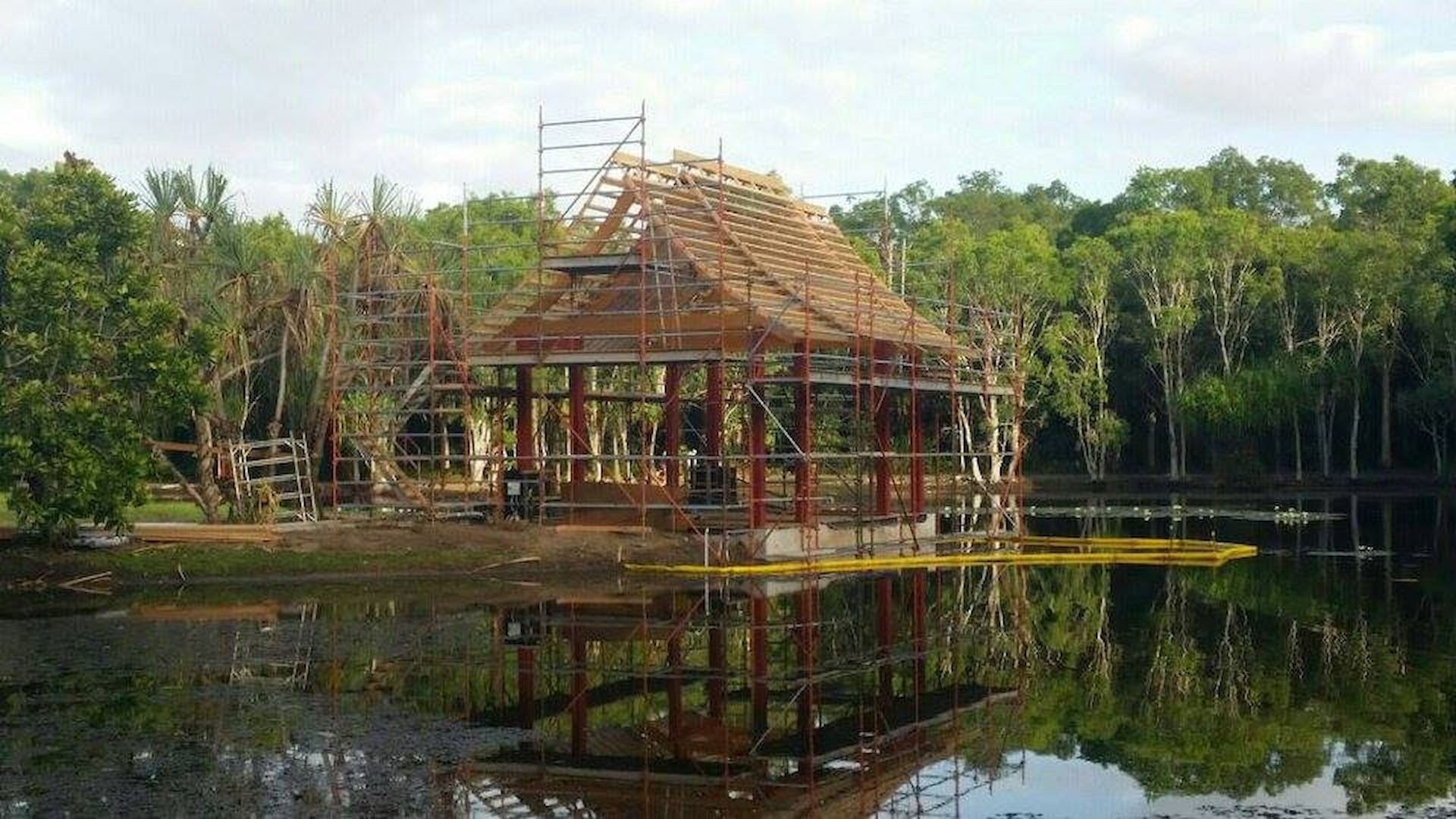 A Structure Under Construction on A Lake, Reflecting the Scene — High Performance Roof Tiling P/L in Kewarra Beach, QLD