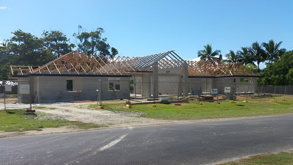 House Under Construction with Gray Block Walls, Wooden Roof Frame — High Performance Roof Tiling P/L in Kewarra Beach, QLD