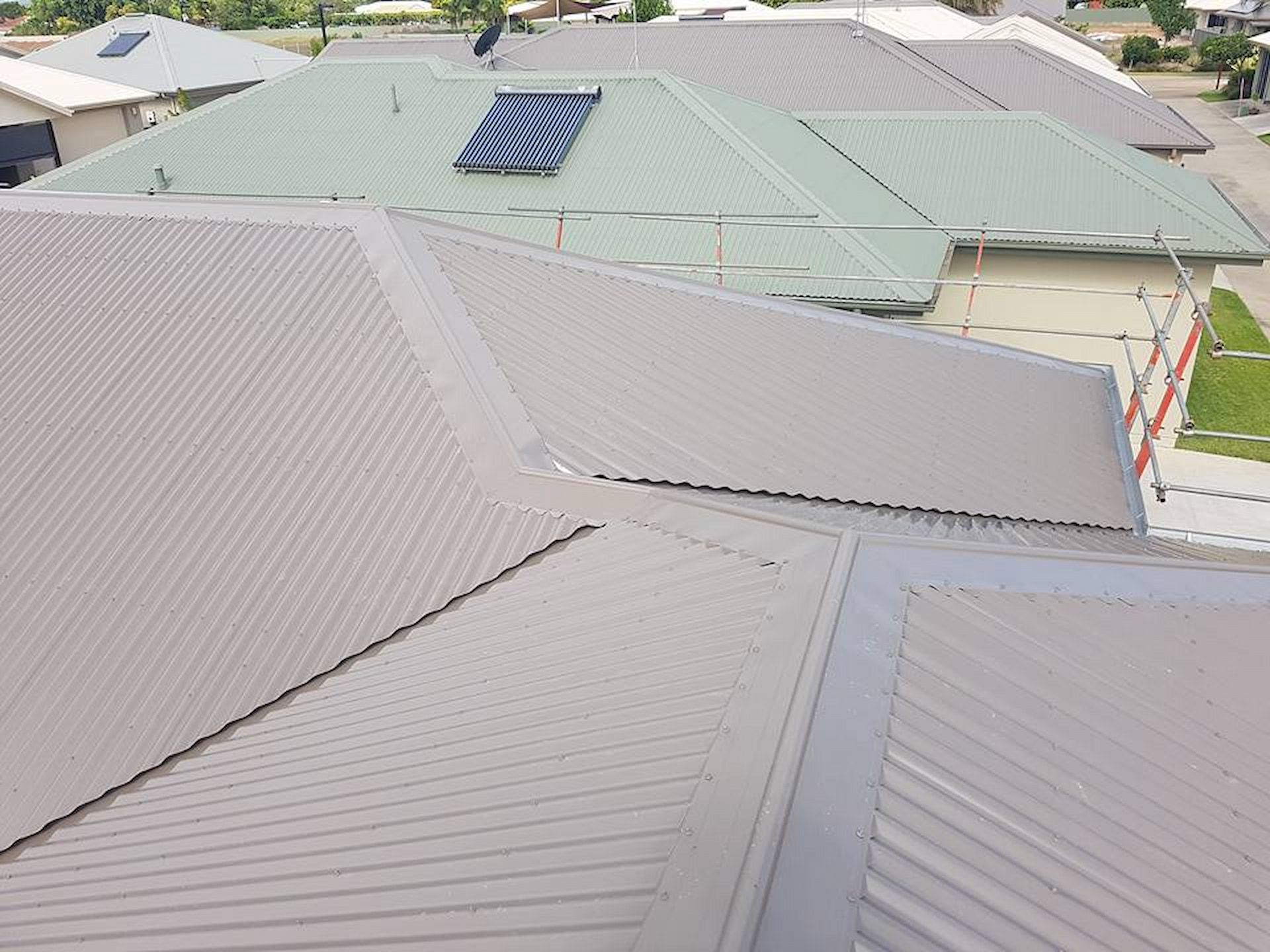Overhead View of Several Houses with Corrugated Metal Roofs — High Performance Roof Tiling P/L in Kewarra Beach, QLD