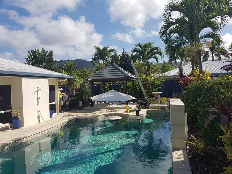 Swimming Pool with Umbrella, Gazebo, and Tropical Landscaping — High Performance Roof Tiling P/L in Kewarra Beach, QLD