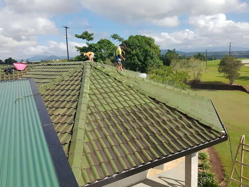 A Group of People Are Working on the Roof of a House  — High Performance Roof Tiling P/L in Atherton Tablelands, QLD