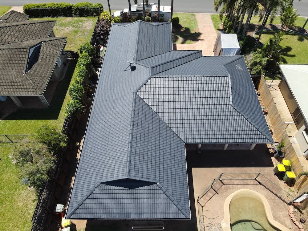 An Aerial View of a House With a Tiled Roof and a Pool  — High Performance Roof Tiling P/L in Port Douglas, QLD