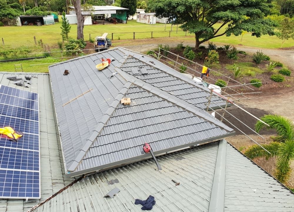 An Aerial View of a Roof With Solar Panels on It — High Performance Roof Tiling P/L in Kewarra Beach, QLD