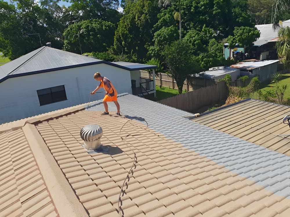 Boy in Orange Shorts on A Rooftop with Tan Tiles — High Performance Roof Tiling P/L in Kewarra Beach, QLD