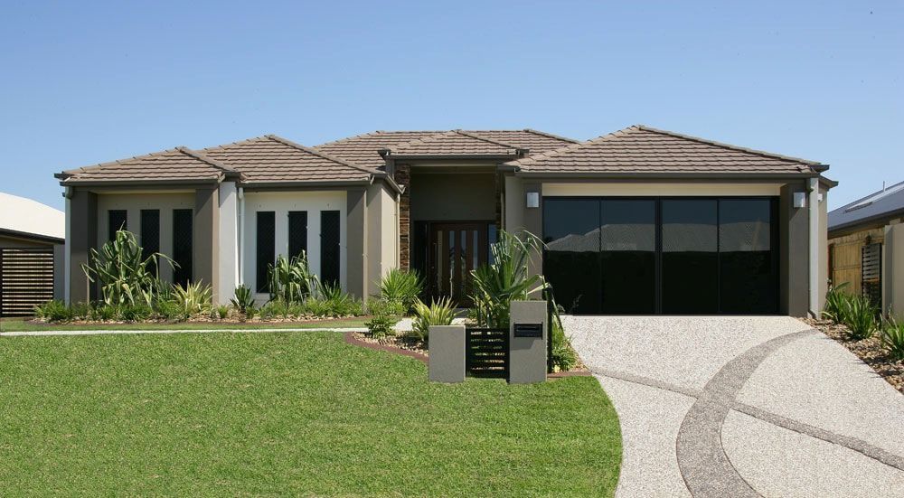 Beige Single-Story House with Brown Roof, Dark Garage Door — High Performance Roof Tiling P/L in Kewarra Beach, QLD