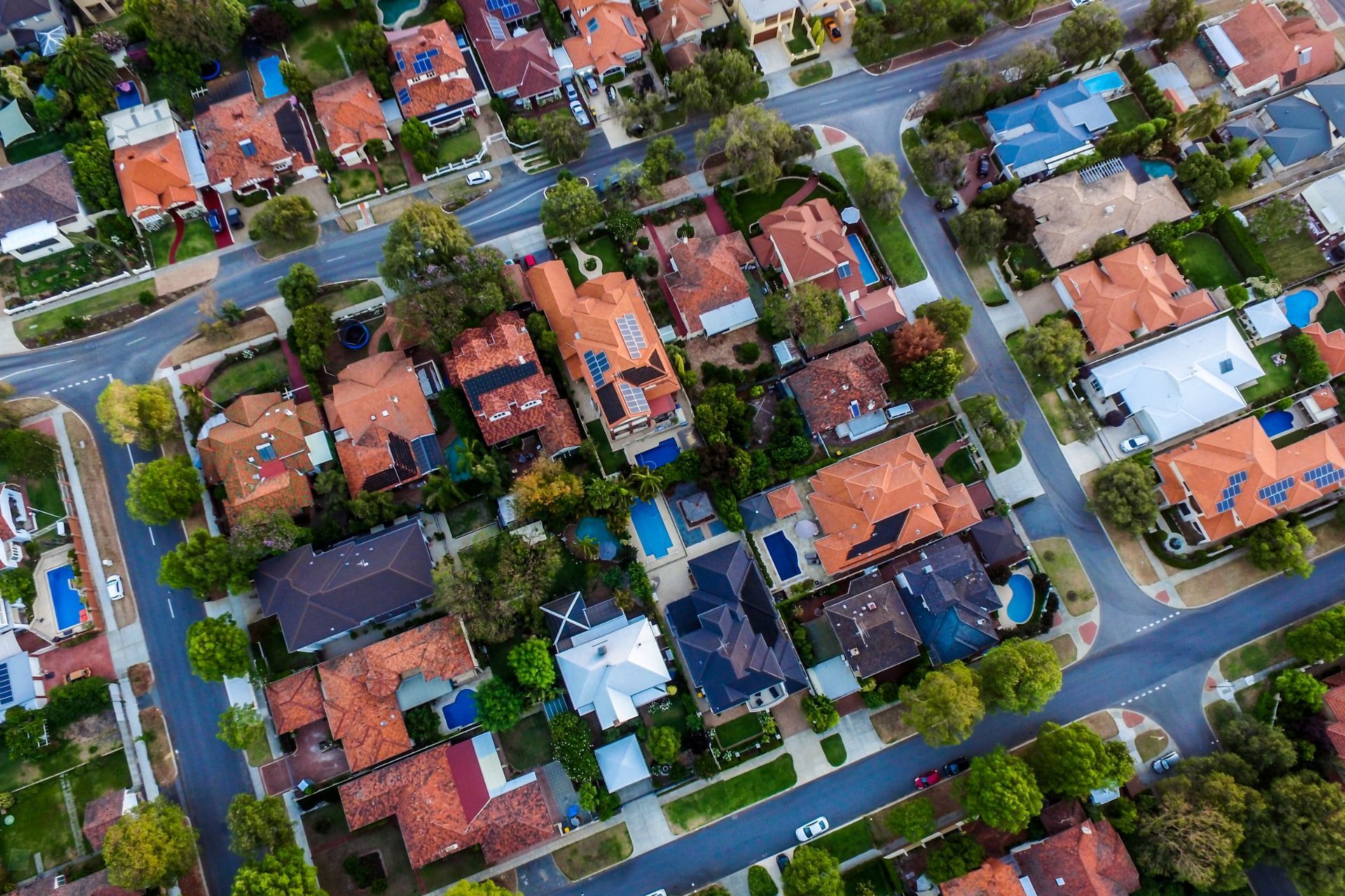 Aerial View of A Suburban Neighborhood with Houses, Streets, Trees — High Performance Roof Tiling P/L in Kewarra Beach, QLD