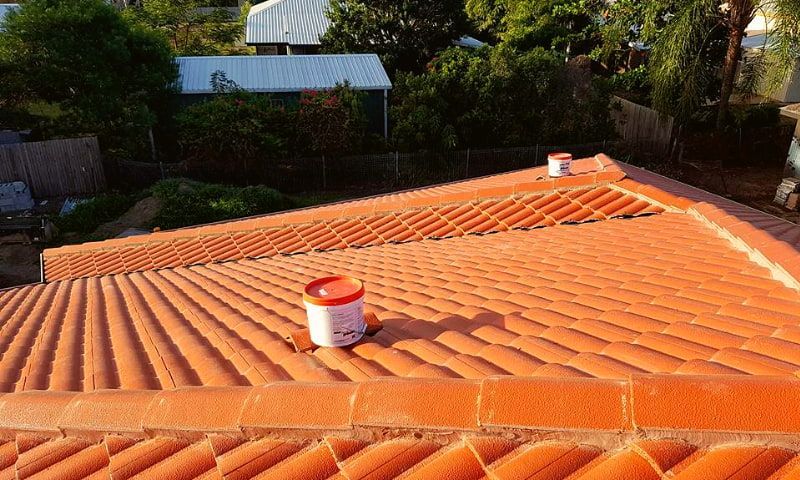 A Can of Paint is Sitting on Top of a Tiled Roof — High Performance Roof Tiling P/L in Kewarra Beach, QLD
