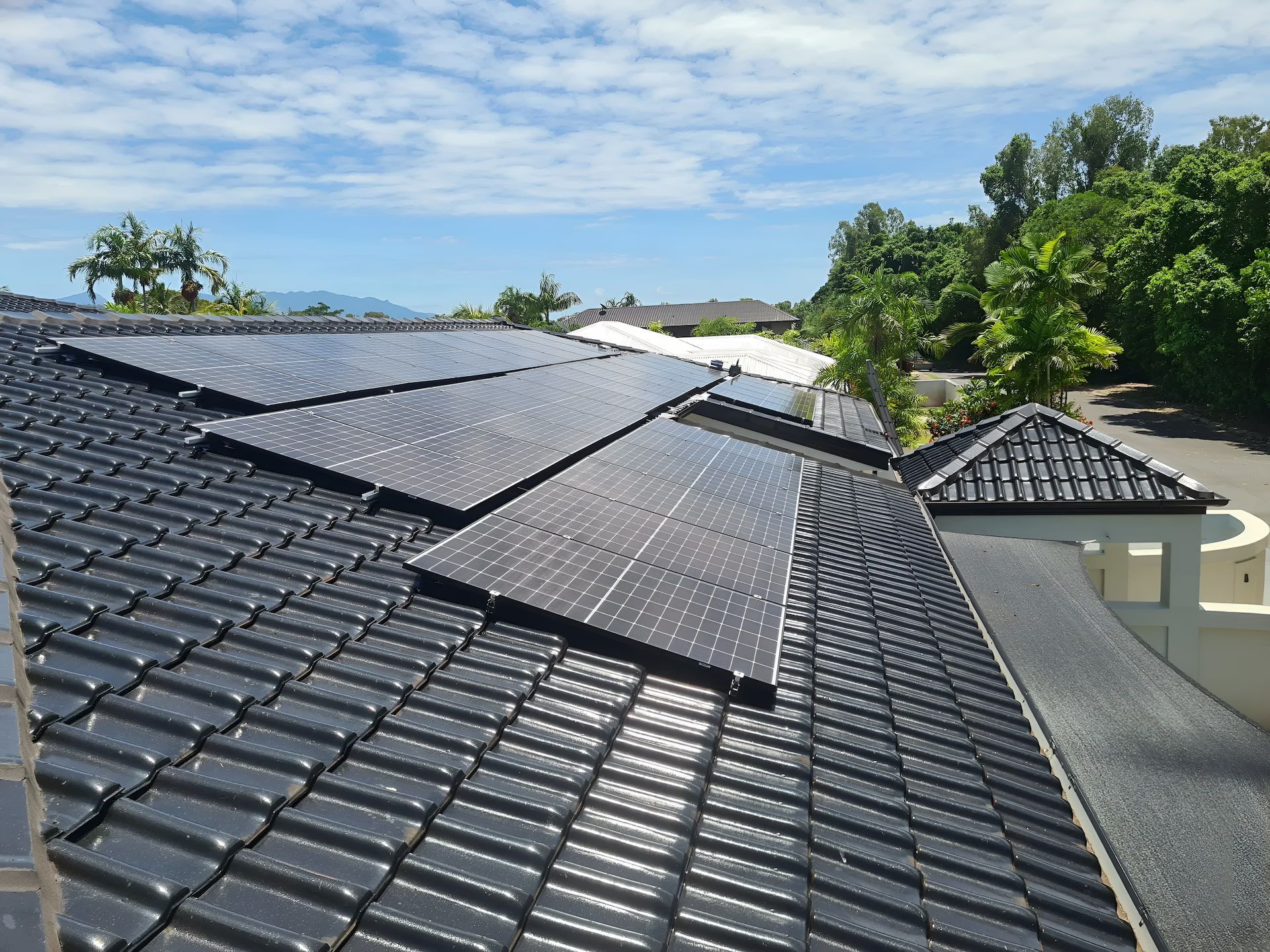 Solar Panels Installed on A Dark Tiled Roof — High Performance Roof Tiling P/L in Kewarra Beach, QLD