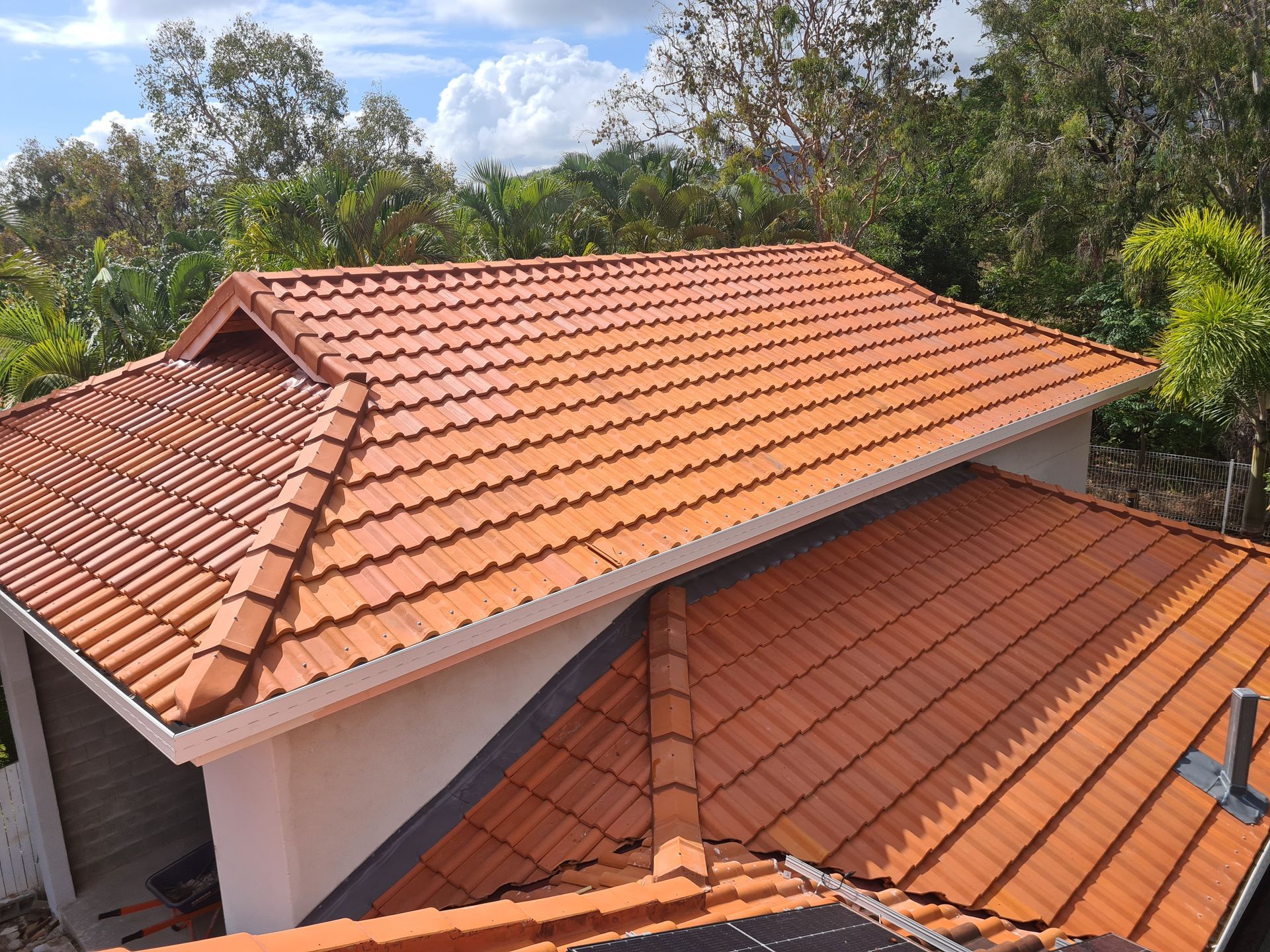 Orange Tile Roof on A House with White Trim — High Performance Roof Tiling P/L in Kewarra Beach, QLD