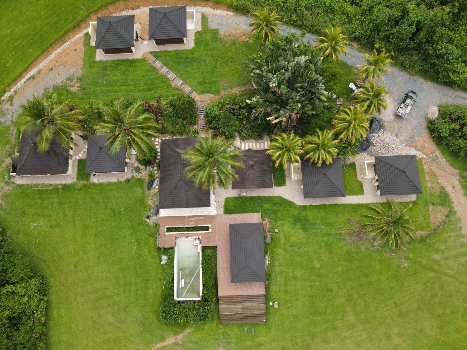 Aerial View of A Tropical Resort with Cabins, a Main Building, and A Pool — High Performance Roof Tiling P/L in Kewarra Beach, QLD