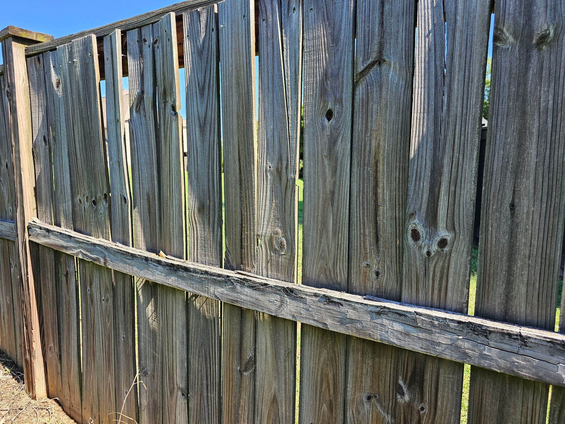 A close up of a wooden fence with a lattice design