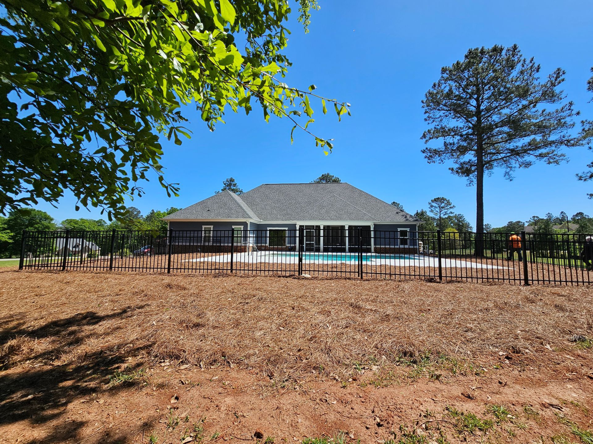 A house with a pool and a fence around it
