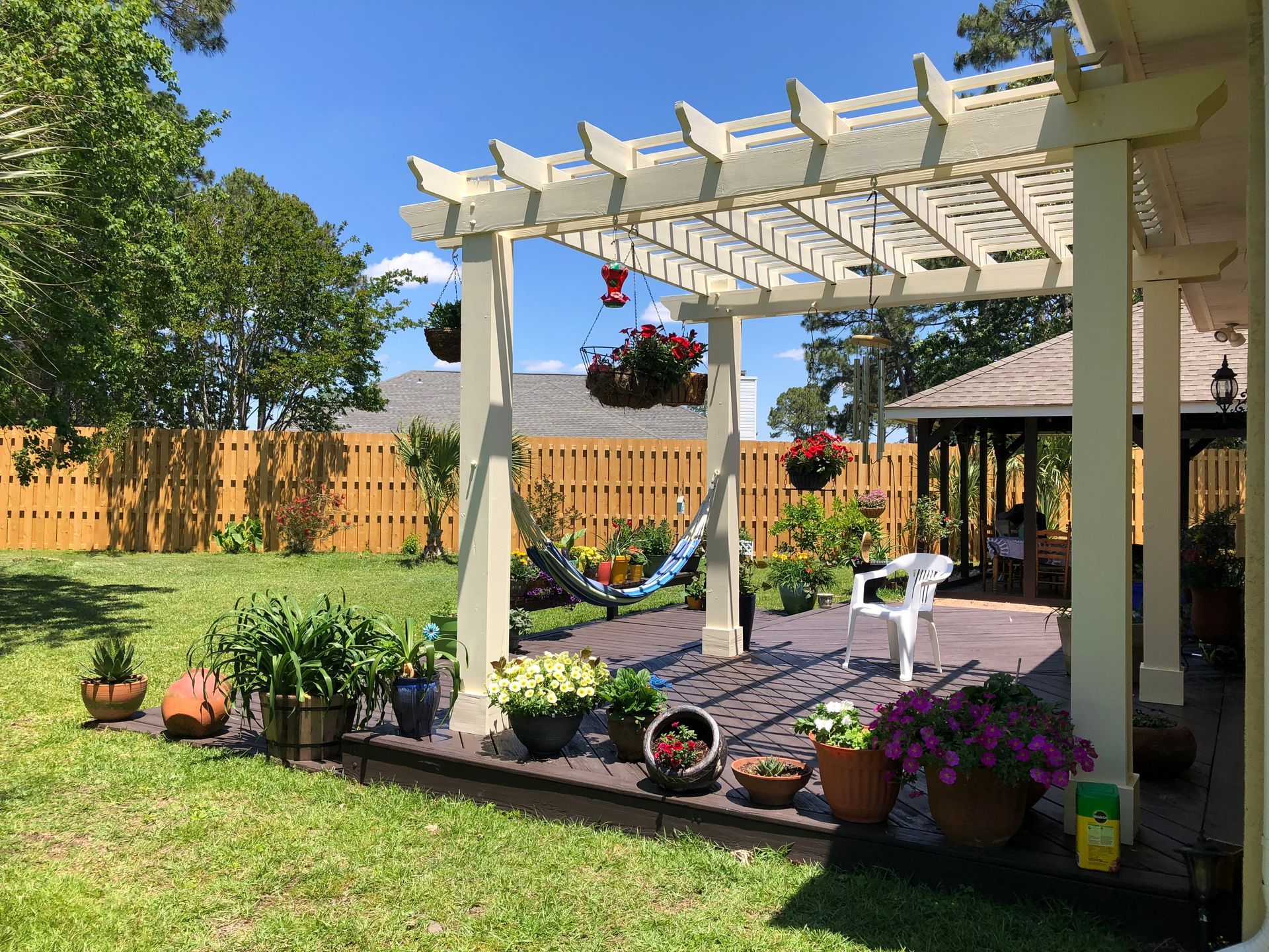 A backyard with a pergola and a hammock