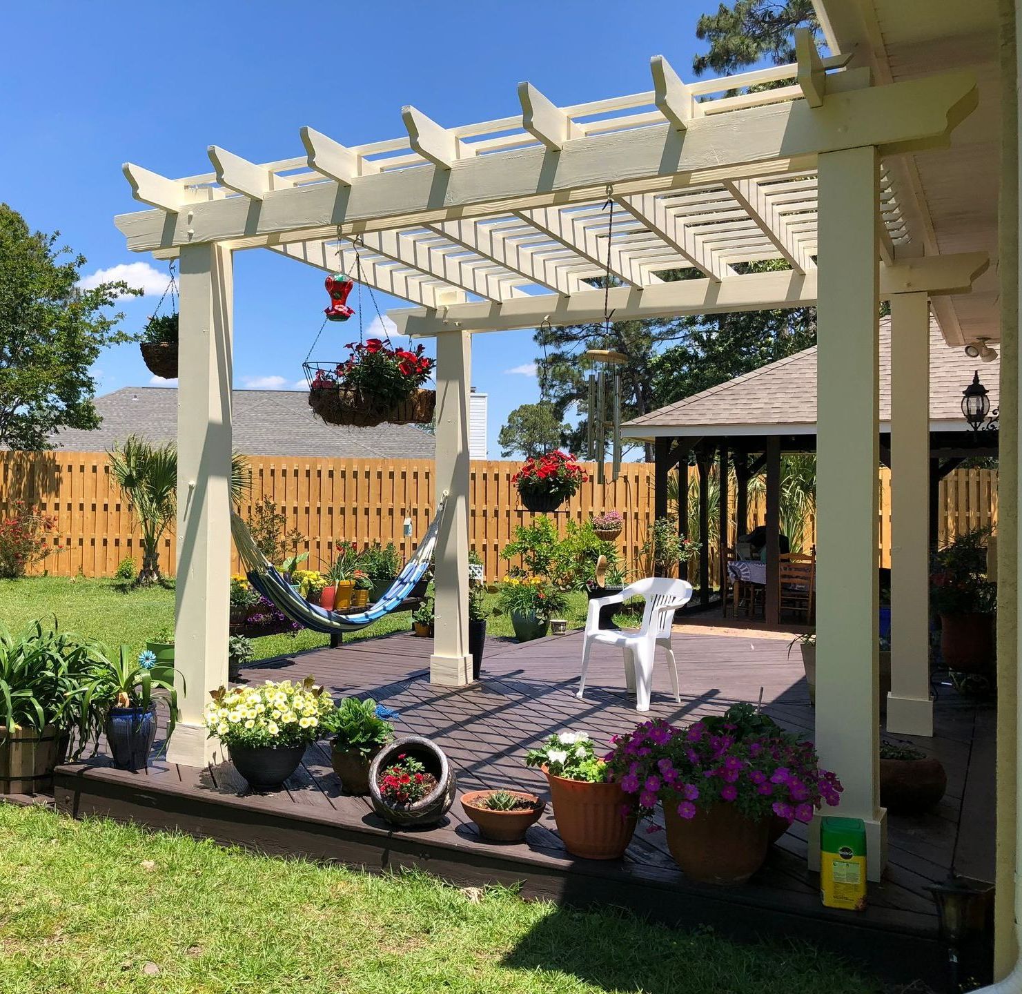 A backyard with a pergola and a hammock