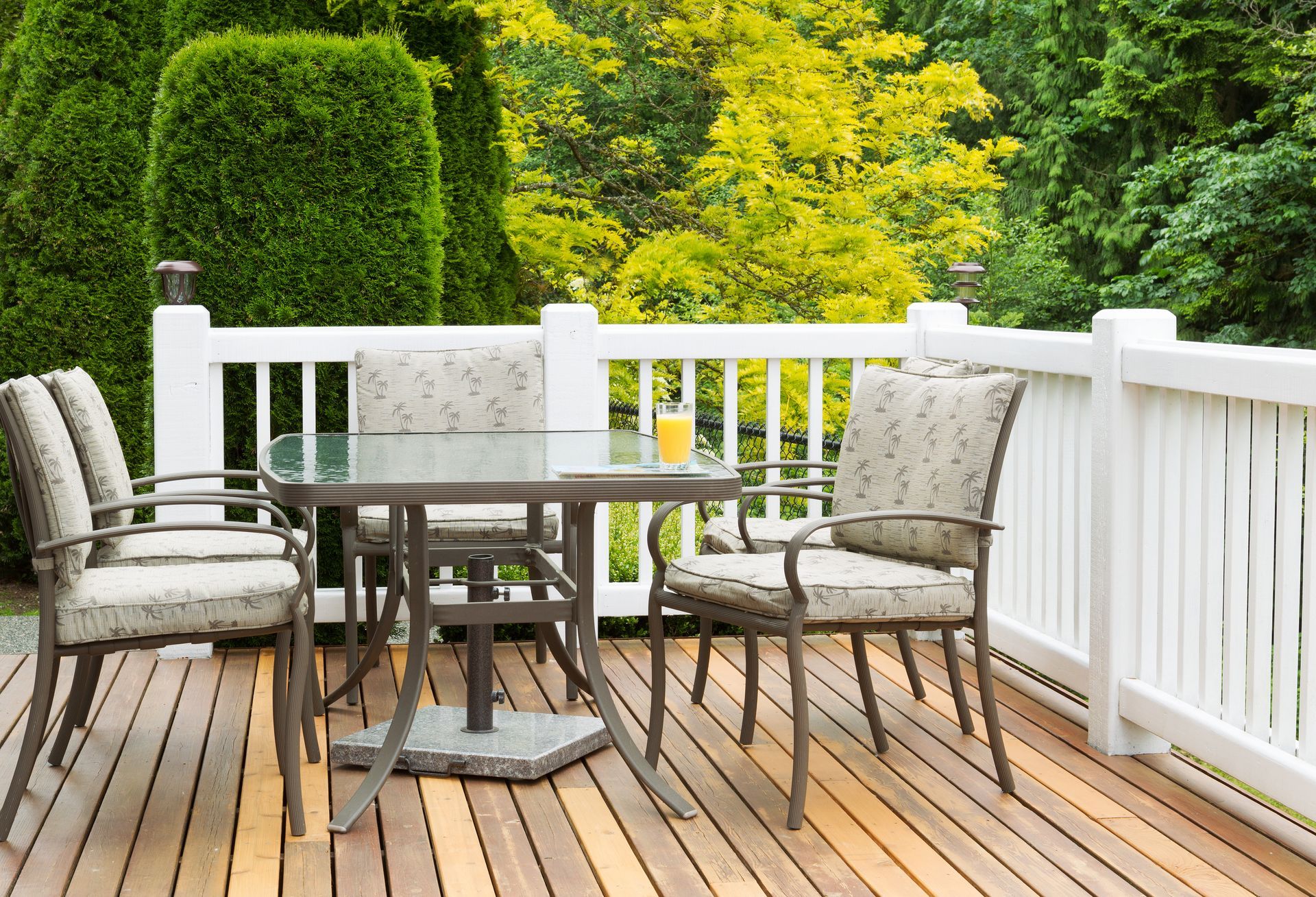 A wooden deck with a table and chairs on it