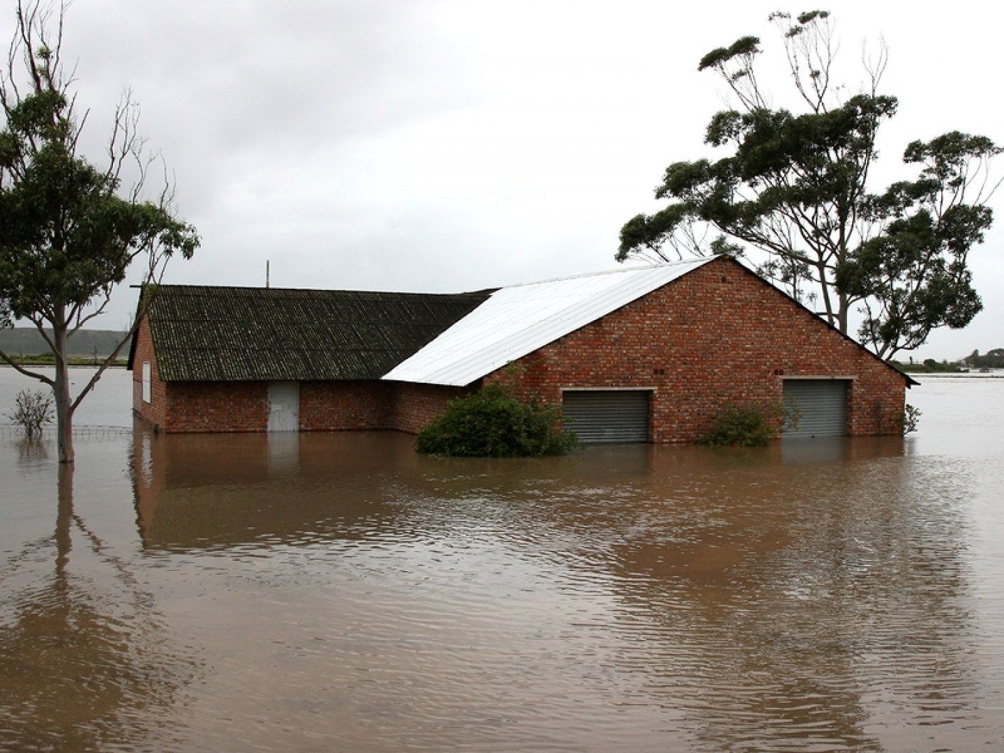 Flooded House on River Bank