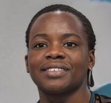 a close up of a woman 's face with a smile on her face