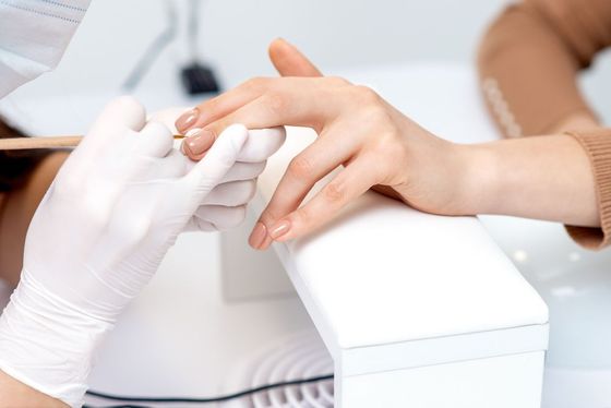 A woman is getting her nails done at a nail salon