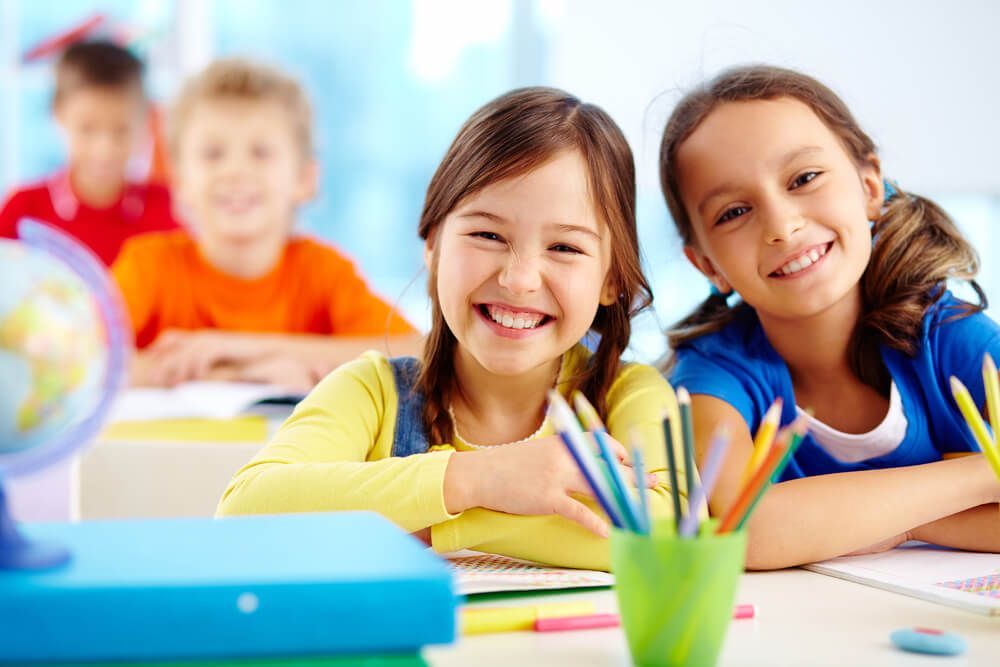 Two Girls Smiling in Classroom Setting — Preschool in Coffs Harbour