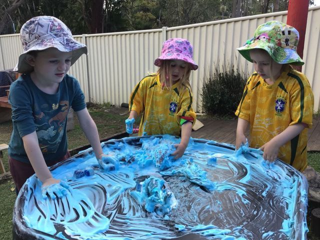Children Engaging in Playful Activities with Blue Foam on a Table — Community Links