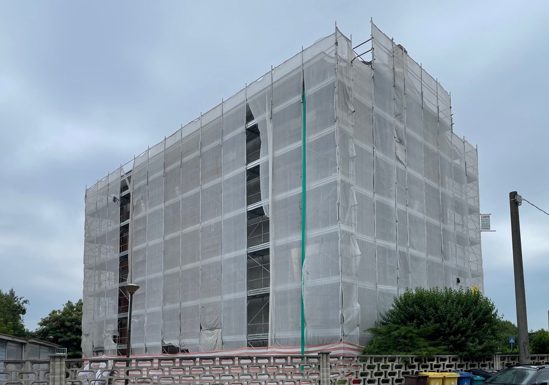 un grande edificio è coperto da impalcature.