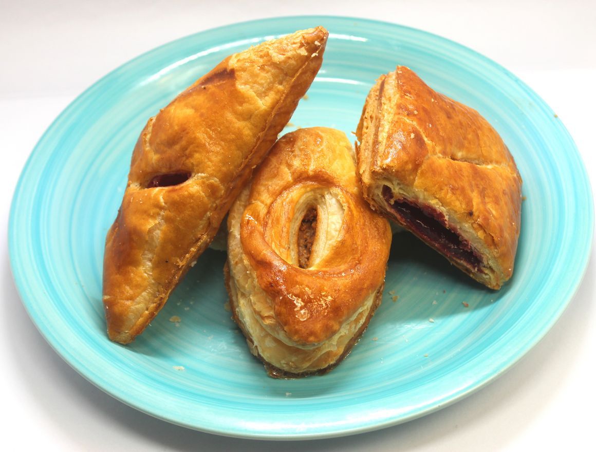 Three golden-brown pastries on a light blue plate.
