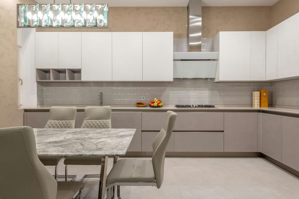 A kitchen with a table and chairs in it