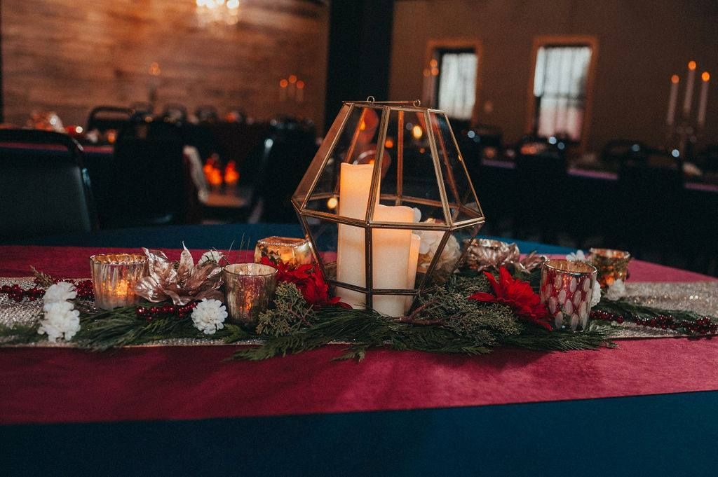A table with a lantern and candles on it.