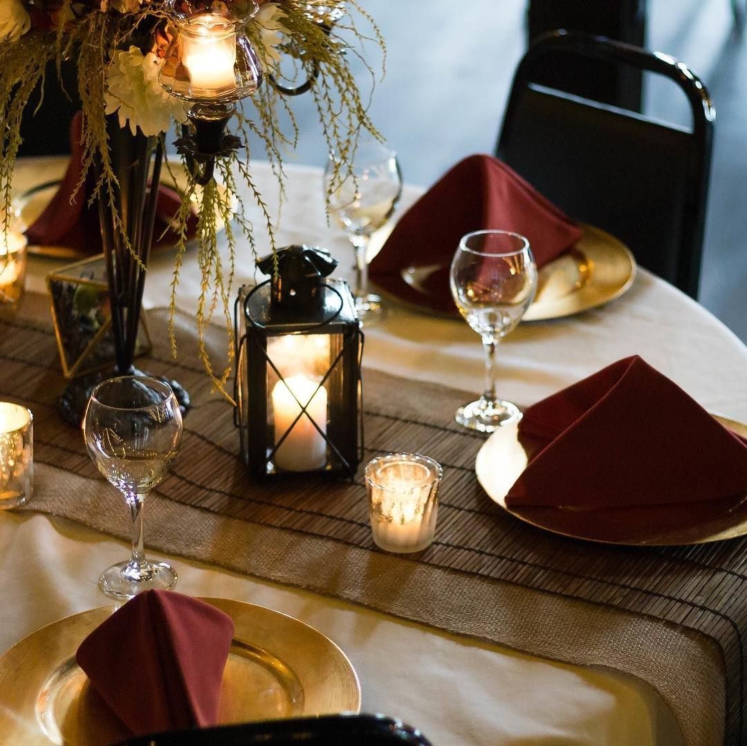 A table set with plates candles and napkins