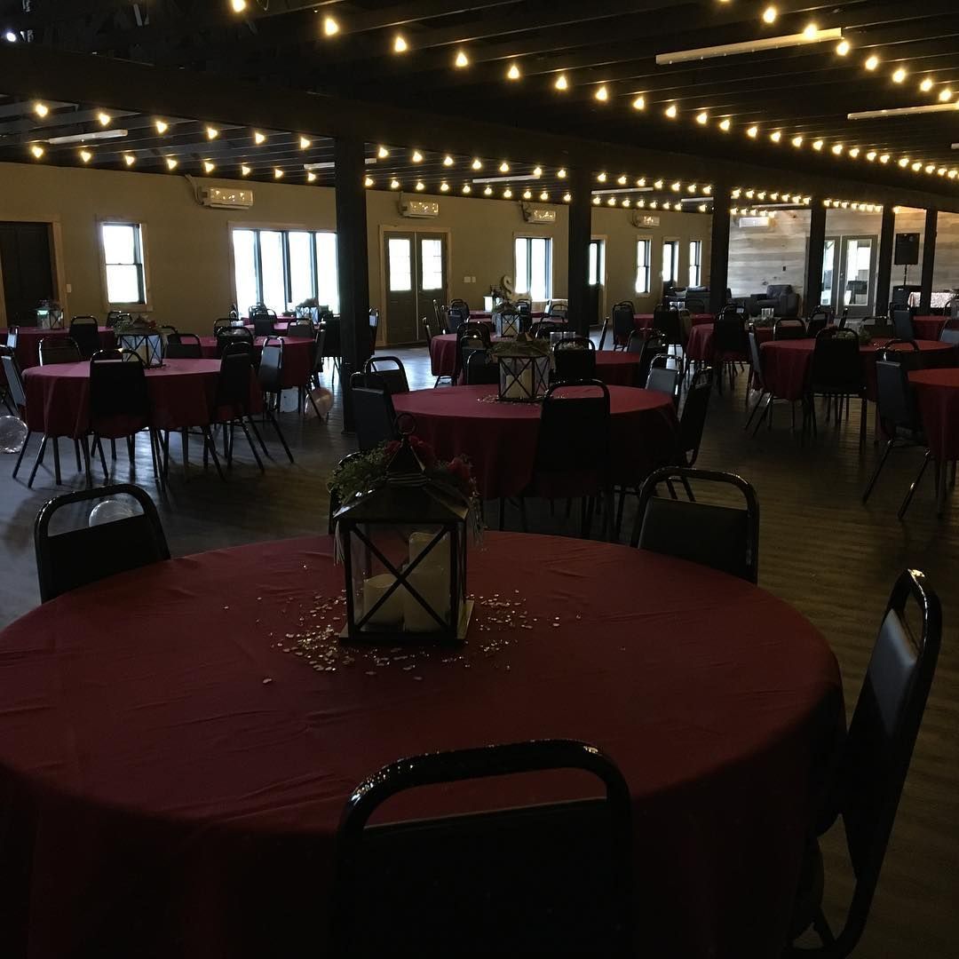 A large room with tables and chairs and a lantern on a table