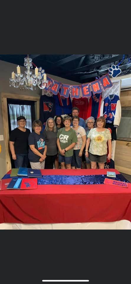 A group of people are standing around a table in a room.