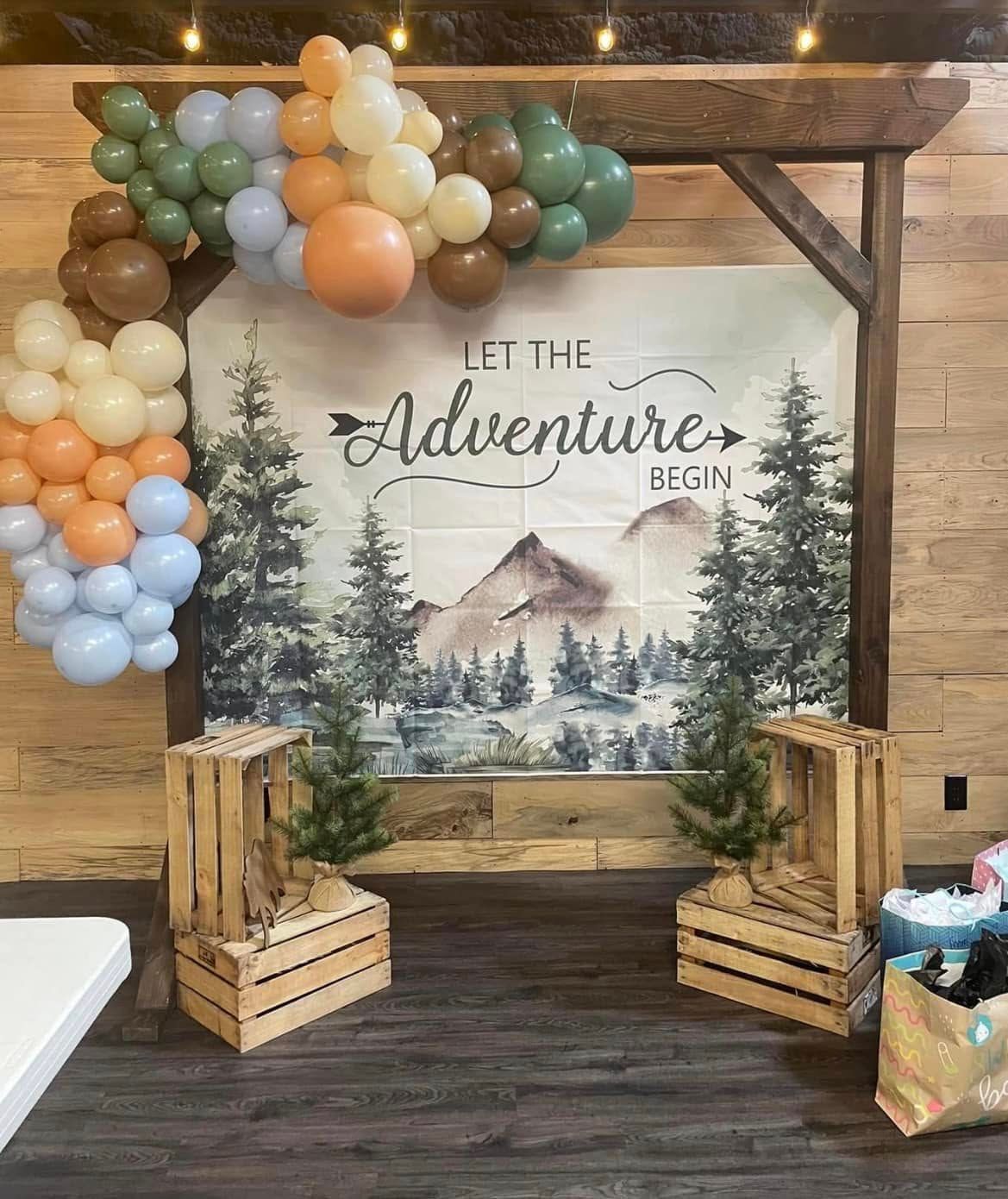 A wooden wall with balloons and crates in front of it.