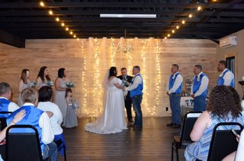 A bride and groom are getting married in front of a crowd of people.