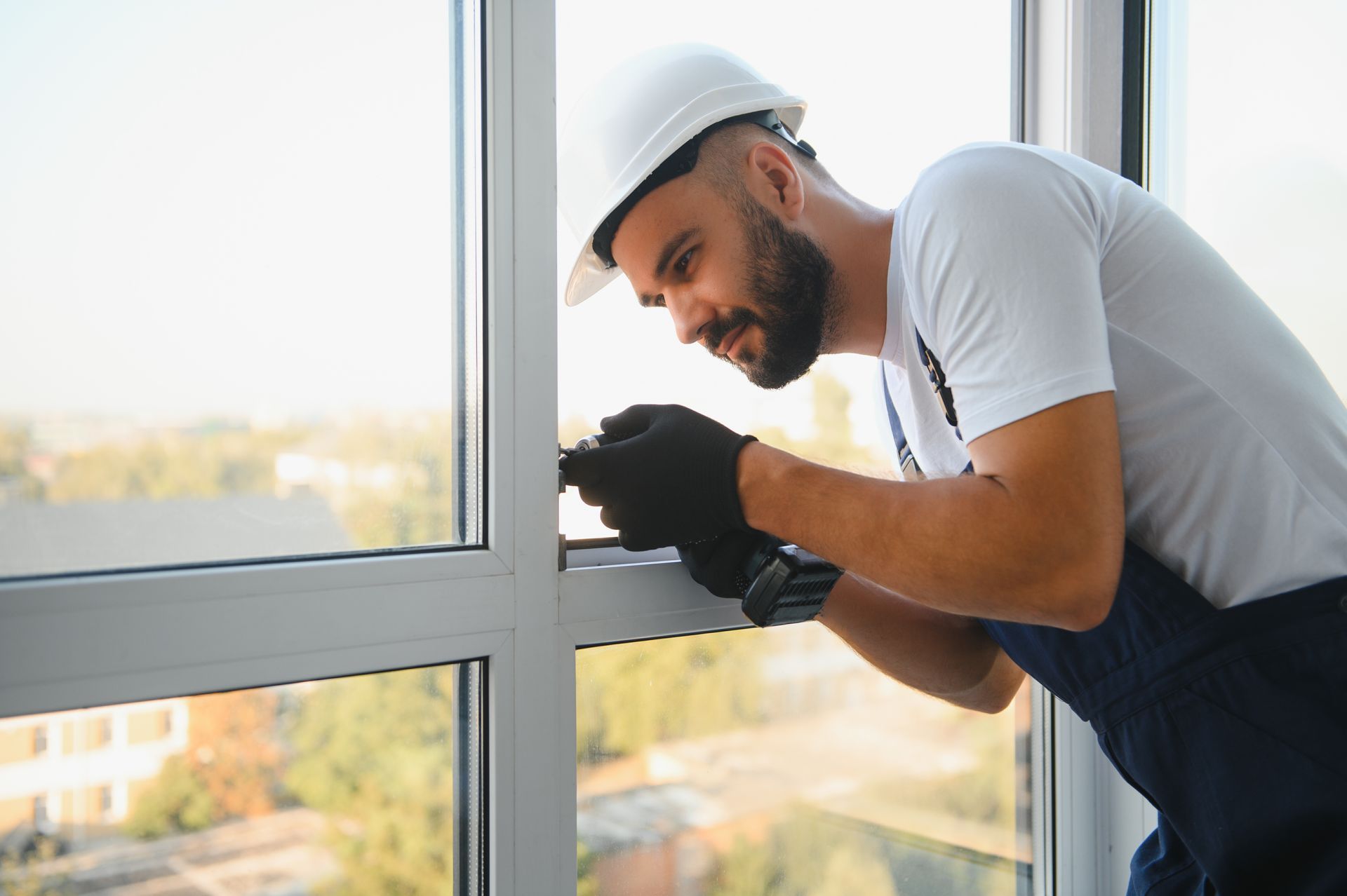 A man is installing a window in a building.