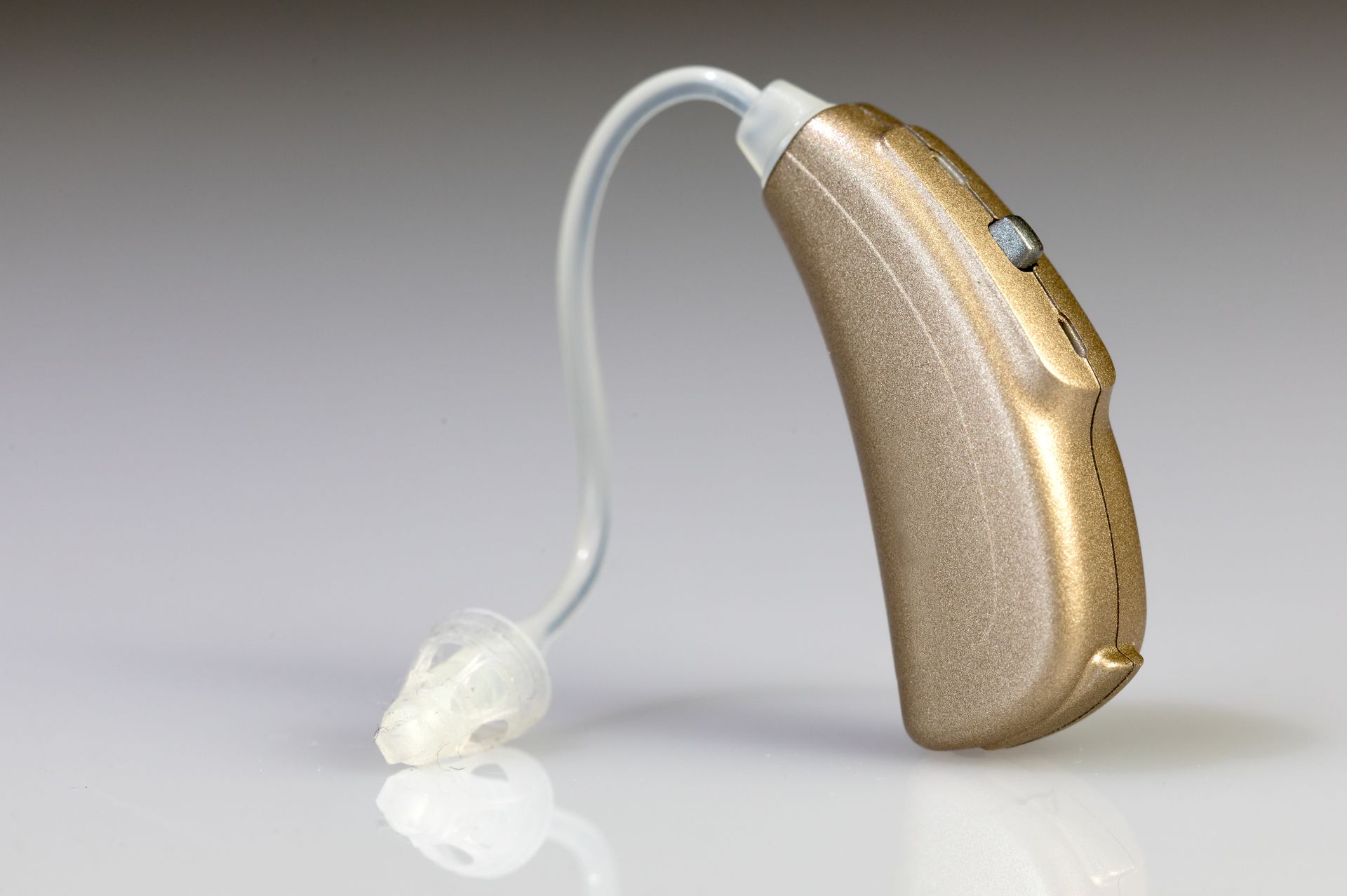 A close up of a hearing aid on a white surface