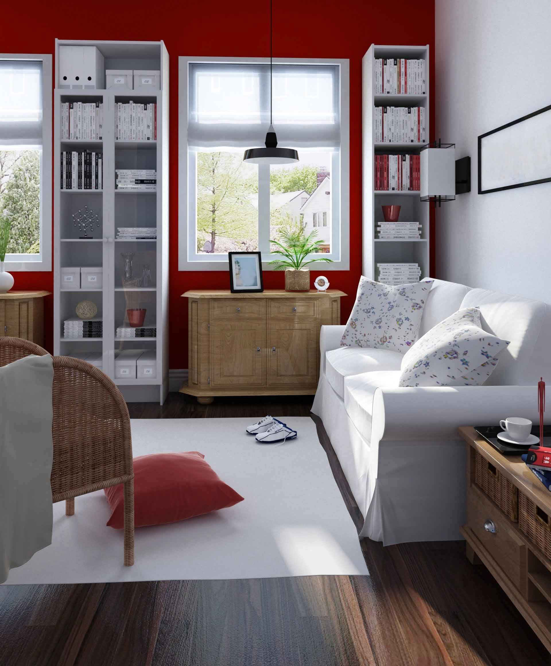 A living room with red walls and white furniture