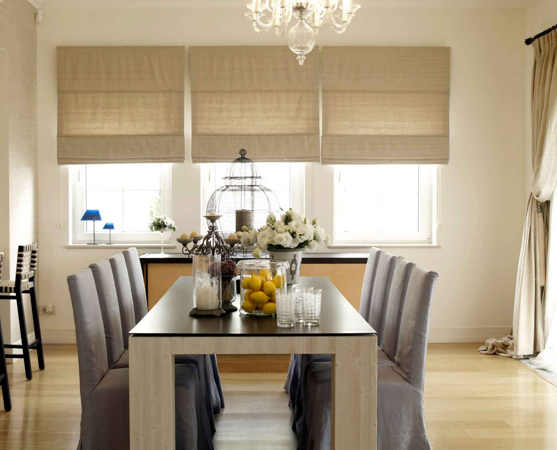 A dining room with a long table and chairs