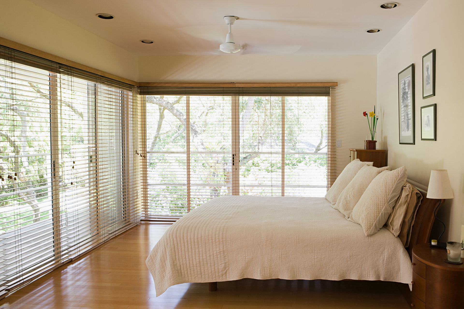 A bedroom with a large bed and lots of windows