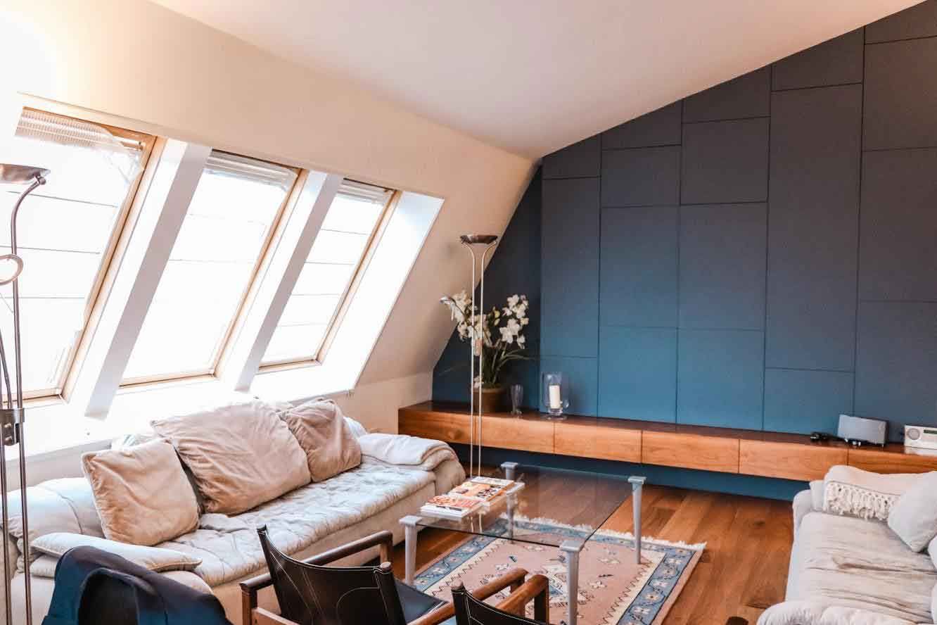 A living room with a couch , chairs , and a coffee table.