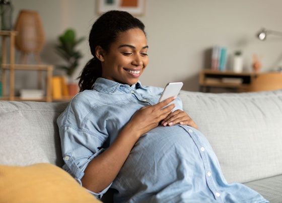 Pregnant Woman Using Phone — Fayetteville, NC — Jones Center for Women’s Health